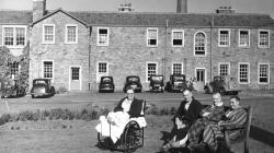 Black and white photo of Beaufort House around the year 1963. The 3rd car from the right is an Austin A35.