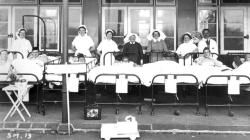 Black and white photo of Patients outside the hospital.