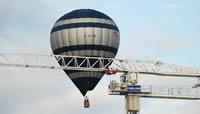 A Crane at Southmead during the build with a hot air balloon behind
