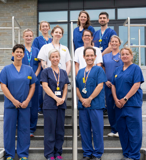 10 members of the vascular testing team stand on stair in 3 rows 10 members of the vascular testing team stand on stair in 3 rows