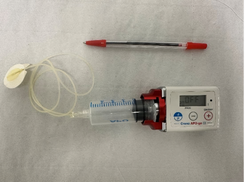 Apomorphine pump with biro pen for size reference