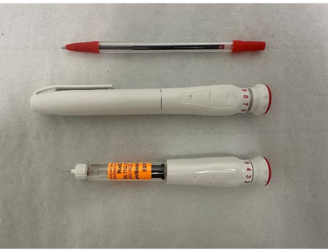 Apomorphine pen with biro pen for size reference