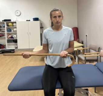 Woman standing with palms facing up gripping a walking stick