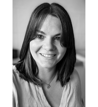 Image of Danielle Banfield Danielle Banfield smiling at the camera. Photo is black and white.