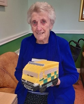 Eileen Photo of Eileen holding her knitted Ambulance shaped tissue box cover