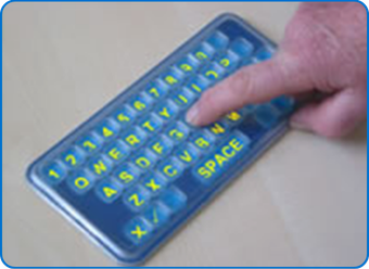 Frenchay Alphabet Board (FAB) on table with finger touching board on letter H