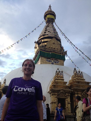 Women and Children's Health Patient Engagement Lead, Midwife Hayley Forbes A woman in a purple T-temple, with the words "Cavell", stands in front of a Nepalese