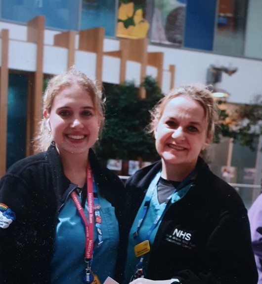 Kristin and Sally are stood together in their uniform smiling.