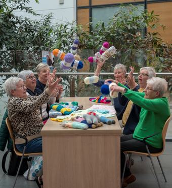 NBT Knitters NBT Knitters sat around a table.