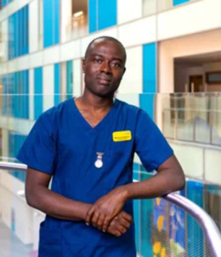 Mordecai Dadzie a Charge Nurse and Band 6 Internationally Educated Nurse pictured in uniform in NBT's Brunel building 