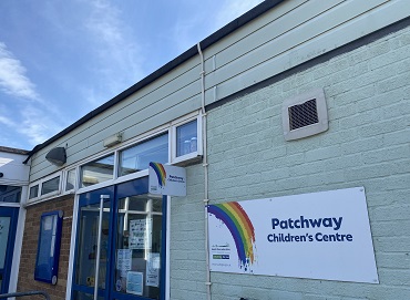 Patchway Children's Centre A low building with a front door, to the right is a sign with a rainbow in the corner and the words "Patchway Children's Centre"