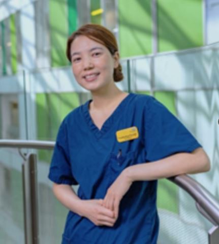 Pratikshya Paudel, Band 6 ICU Sister at NBT, posing in uniform in Brunel building corridor