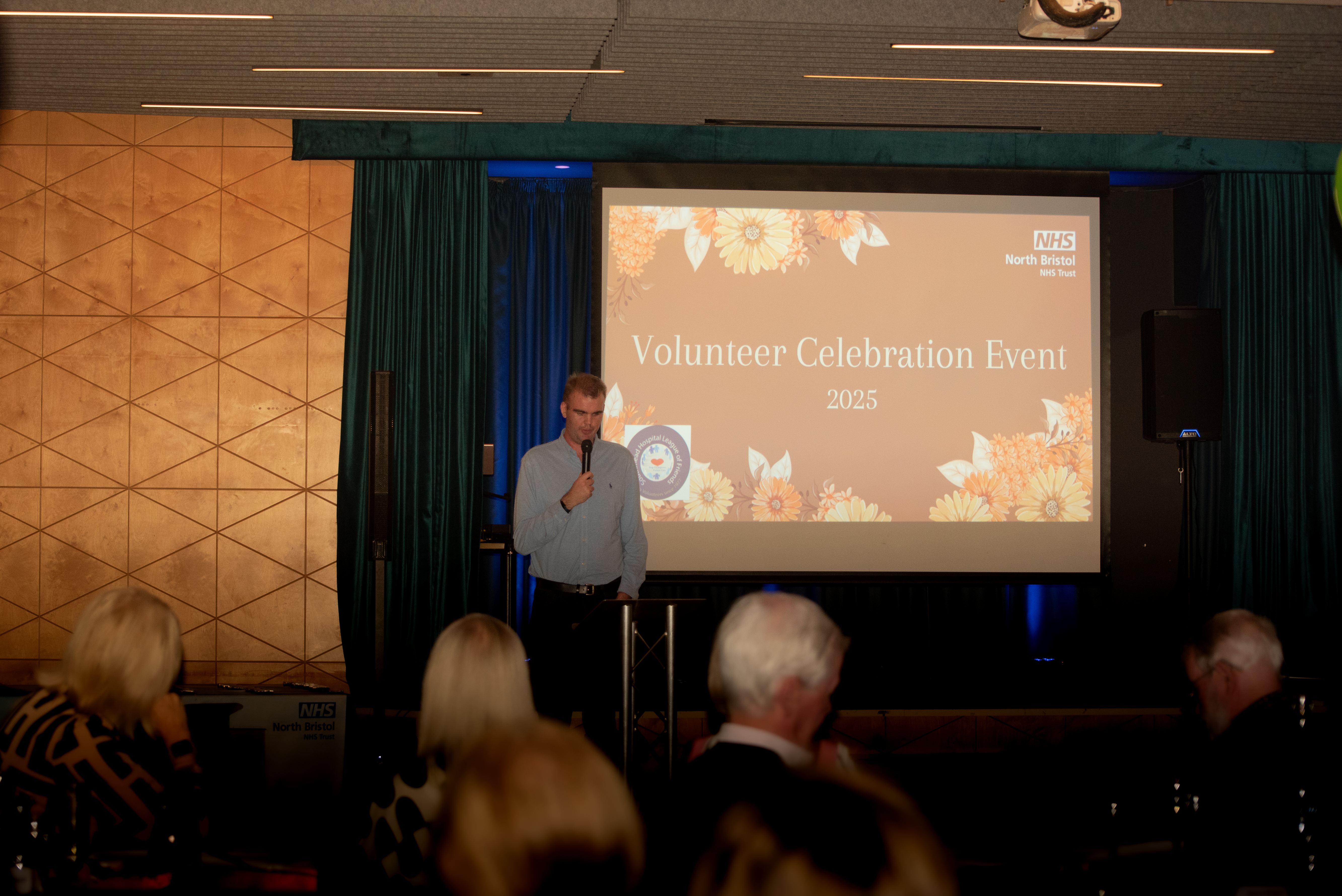 Person at volunteers event in front of powerpoint