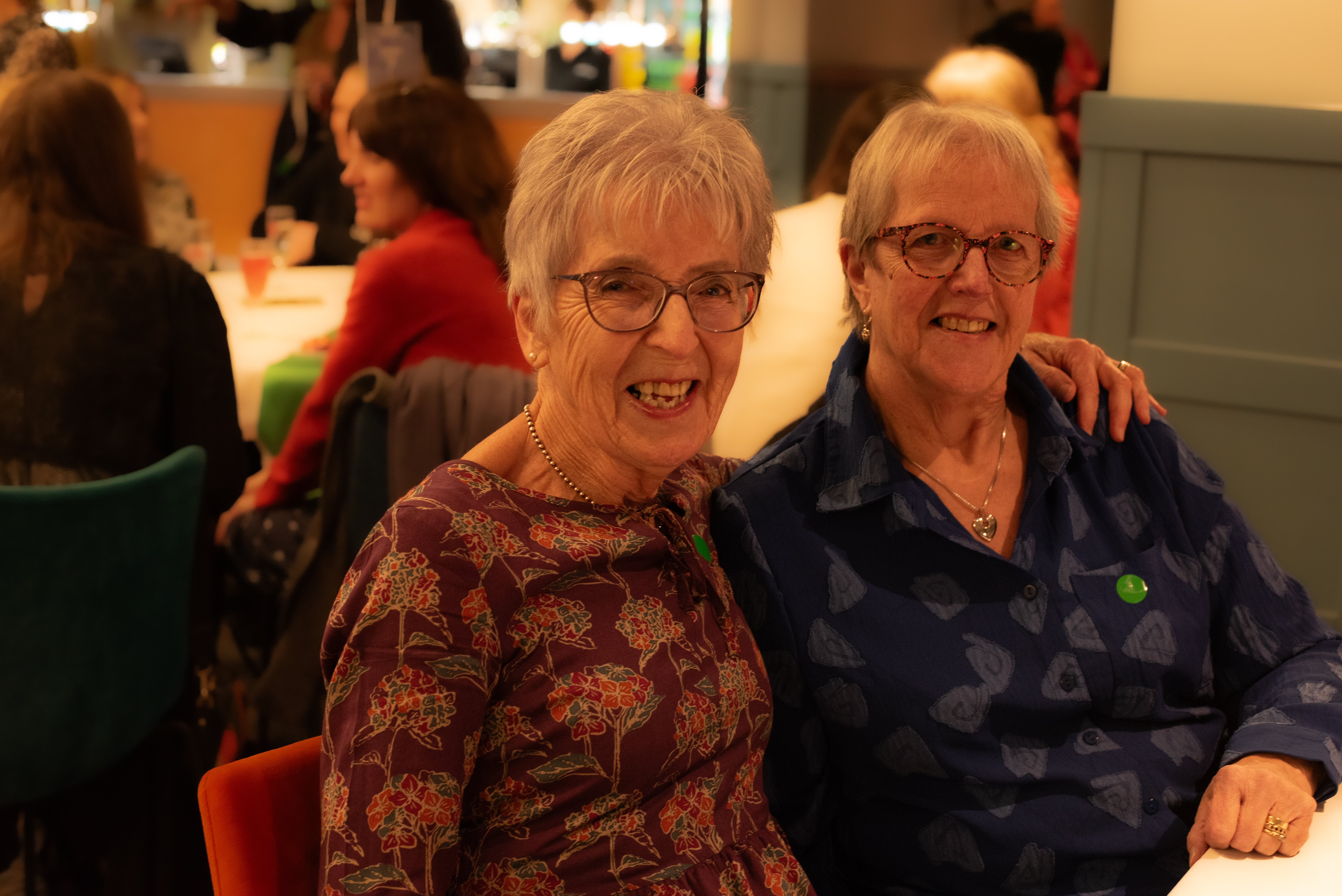 Two people looking at the camera at the volunteers event