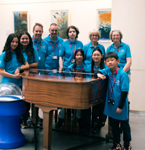 Volunteers by the piano. Volunteers by the piano.
