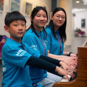three young people playing the piano.png three young people playing the piano.png