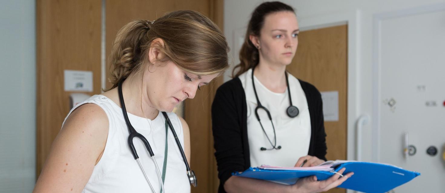 Two doctors reviewing notes