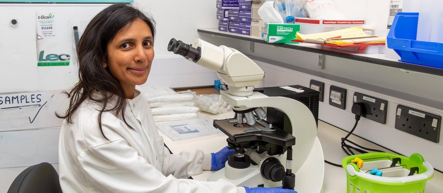 Pathology doctor using a microscope