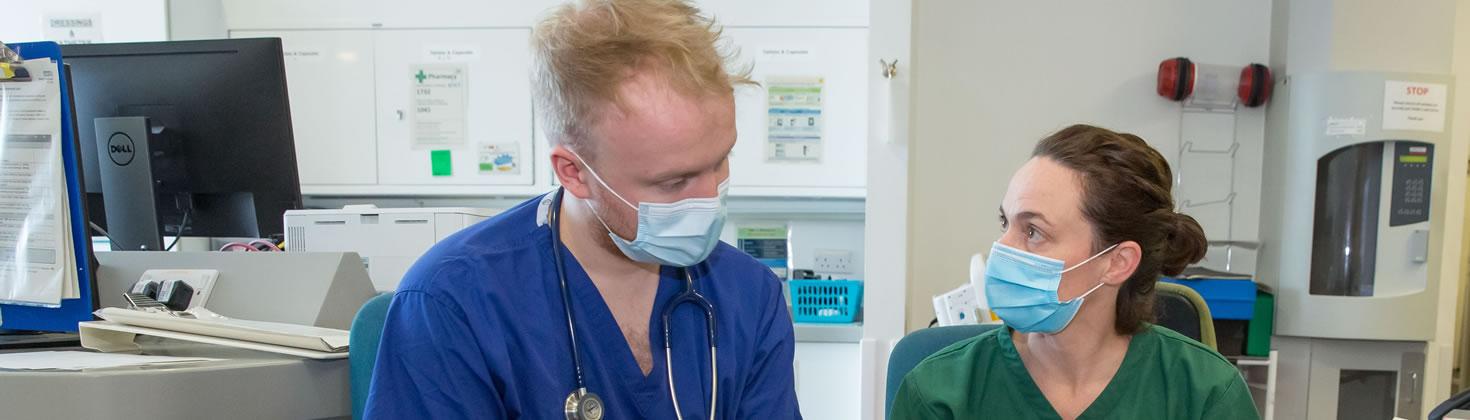 Two members of staff in masks