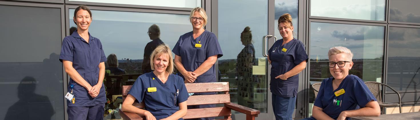 Members of staff outside a building