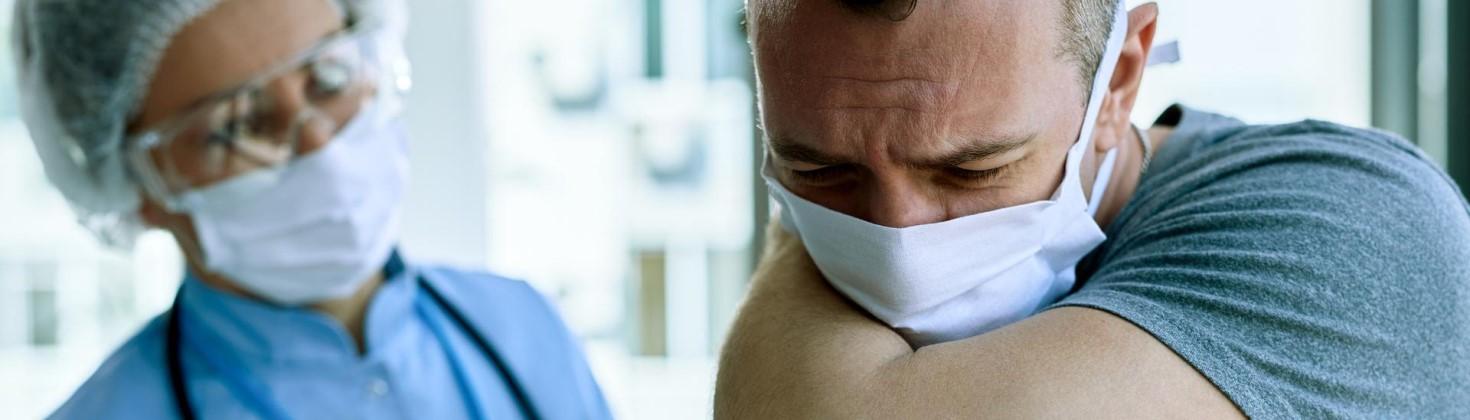 Patient coughing into the crease of his arm