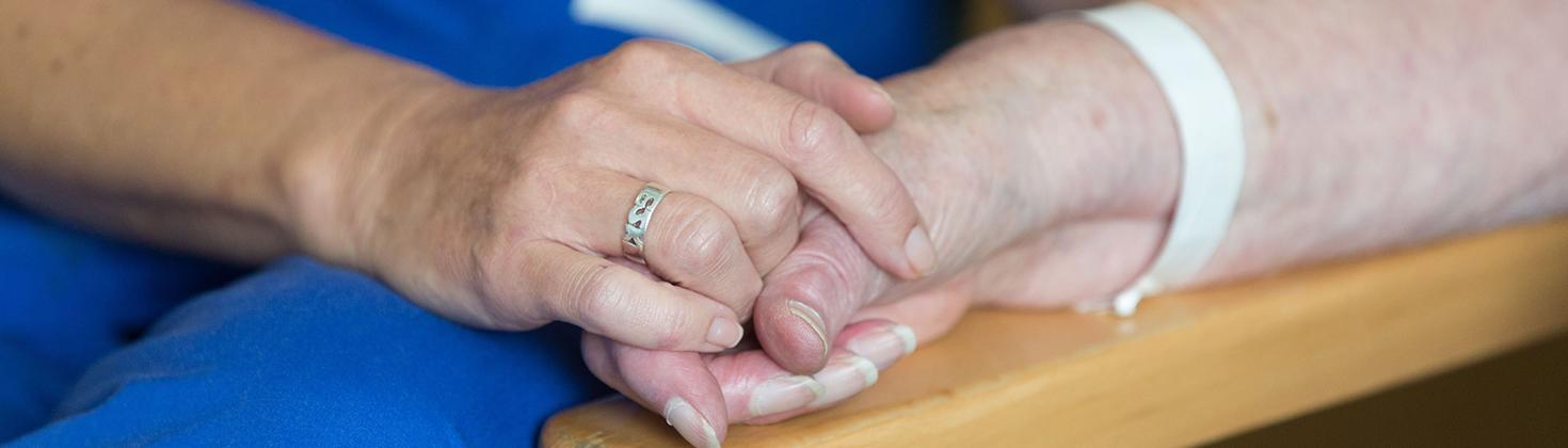 Nurse holding hands with patient