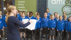 Horfield Primary School Choir performs in the entrance to the Brunel building.