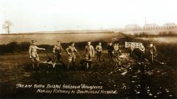 Black and white photo of The 2nd Batt'n Bristol Coliseum volunteers making a pathway to Southmead Hospital 1917.