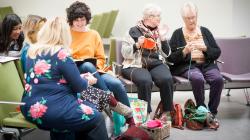 Knitters knitting Twiddlemuffs as part of our Knit With Me project - Image Clint Randall.