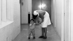 Black and white photo of A nurse in the main corridor at Southmead Hospital.