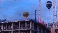 Camera photo Taken during the balloon fiesta August 2011 - 2 balloons over the building work