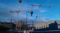 Camera photo of 2 Balloons above the cranes. Taken during the balloon fiesta August 2011. Submitted by Charlie Tomson.