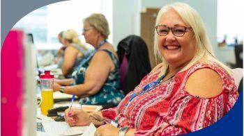 Image of smiling lady at desk