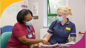 Two nurses working with masks on