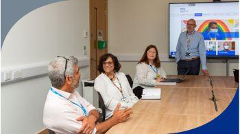 People sitting around a board table People sitting around a board table