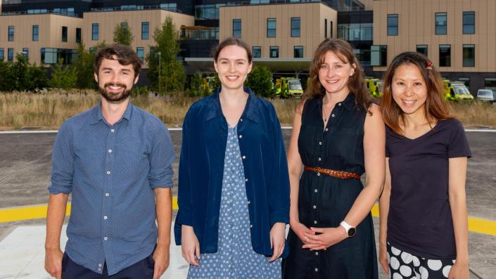 NHS staff standing outside in front of buildings