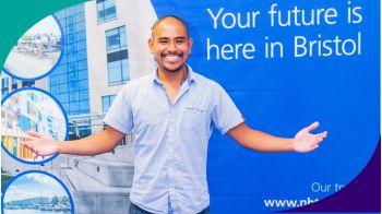 Man standing in front of recruitment banner