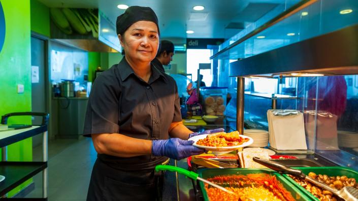 Chef in canteen showing off food