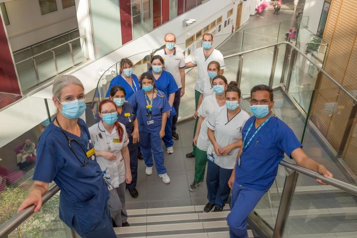 nurses and therapists group photo on stairs