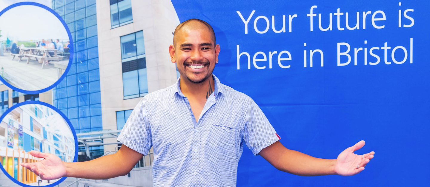 Recruitment Journey Banner - Your Future is here in Bristol. Man smiling with arms spread wide in from of big blue NBT poster