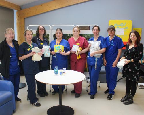 Colleagues from Maternity Services holding up items found in the Baby Bank emergency 'grab bag'