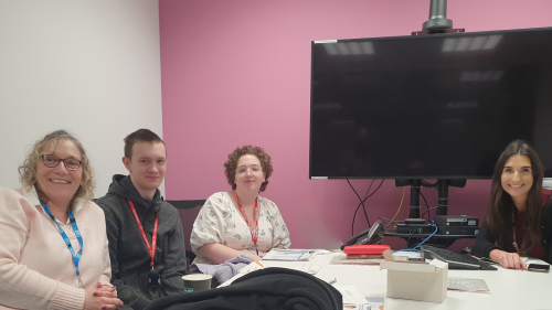 Two young carers and two members of staff from NBT sat around a table