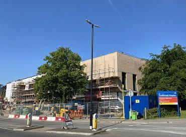 The Elective Centre, Southmead Hospital in May 2025 A building with a hospital sign next to it and trees in front and to the side of it