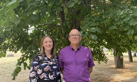 Lead Medical Examiner Officer Charlotte Clews and Medical Examiner Dr David Crossley Two people stand in front of a tree