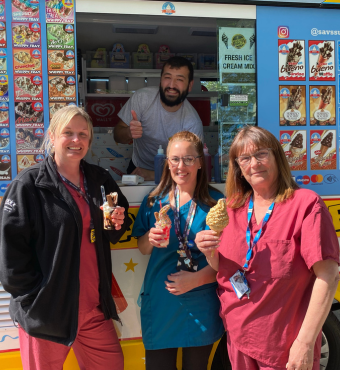 Midwives receiving ice creams on International Day of the Midwife A group photo of three maternity services colleagues holding ice creams and smiling in front of an ice cream van, and an ice cream server smiling whilst doing a thumbs up pose