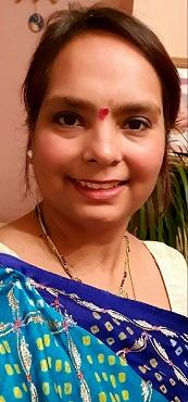 Pooja, North Bristol NHS Trust nurse who came to the UK in 2002 A woman in cultural dress smiles at the camera
