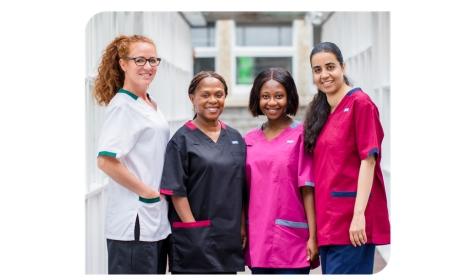 Four colleagues stood looking at the camera