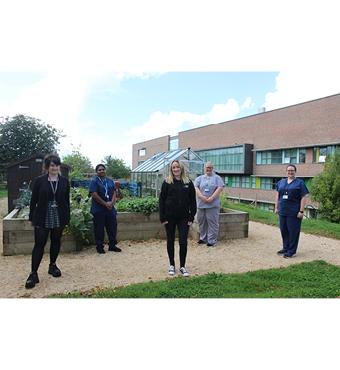 Image of five people standing outside 