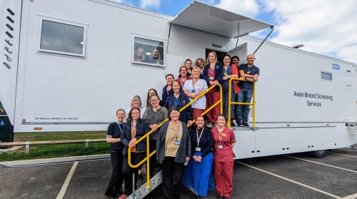 A group of around 20 NBT staff members stood outside the new mobile screening unit at Southmead Hospital