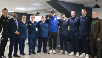 Members of Bristol Rovers, Bristol Rovers Community Trust, North Bristol NHS colleagues and UHBW colleagues stood in a semi circle at the CPR Session